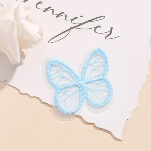 Detail view of light blue organza butterfly embroidery patch for hair accessories and clothing.
