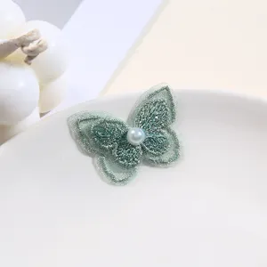 Green lace embroidery butterfly patch with pearl detail, perfect for DIY clothing decoration.