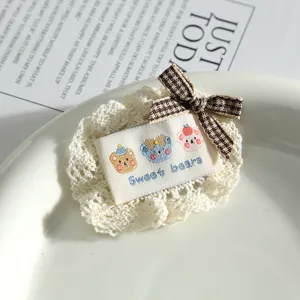 Cute lace patch with plaid bow and embroidered bear label for DIY clothing and crafts decoration.
