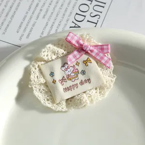 Lace fabric patch with cute bunny embroidery and pink bow for clothing DIY decor.