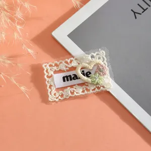 Exquisite lace embroidery patch with heart and flower design, ideal for DIY clothing decoration.