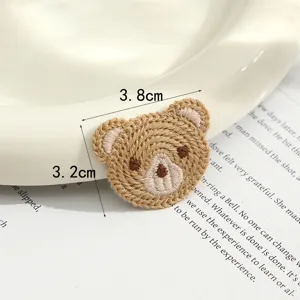 Close-up detail of a cute brown bear embroidery cloth patch, perfect for DIY crafts and accessories.