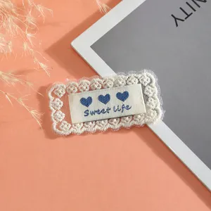 Exquisite lace embroidered patch with sweet life text and cute hearts for DIY clothing decor.