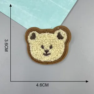 Fluffy bear patch detail, cute embroidered design with soft texture for DIY clothes.