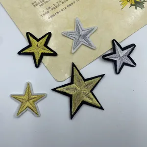 Detailed close-up of gold and silver star embroidery patches, ideal for DIY apparel decor.