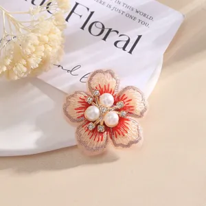 Gedetailleerd overzicht van geborduurde bloemenpatch met 5 bloemblaadjes, parels en strass voor DIY.