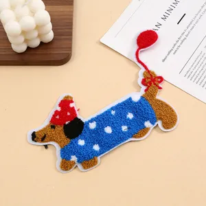 Detailed close-up view of a cute cartoon dachshund towel embroidery patch in flat lay style.
