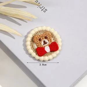Cute brown bear embroidery patch with red bow for DIY clothing accessories decoration.