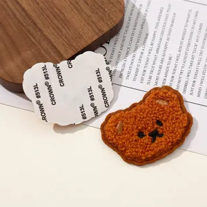 Cute brown bear embroidery patch for clothes and bags DIY accessories close up detail view
