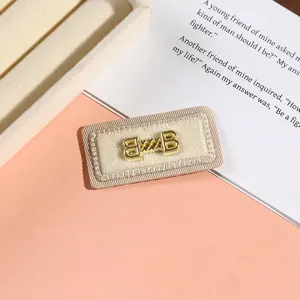 Exquisite rectangular embroidered fabric patch with gold metal hardware, ideal for DIY fashion.