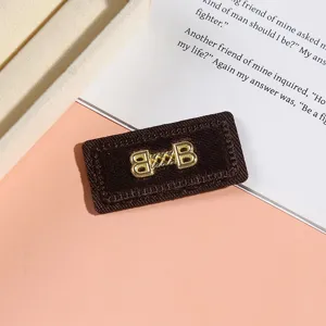 Brown velvet rectangular clothing patch with gold letter embroidery for DIY fashion accessories.