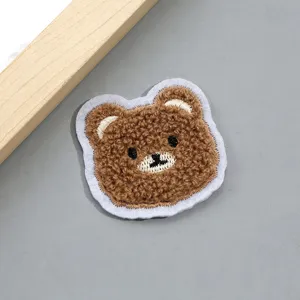 Cute plush bear patch for clothing DIY decoration, fluffy fabric applique for hat bag details.