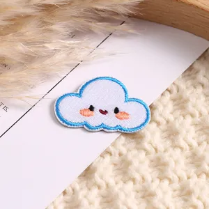 Cute embroidered cloud patch with smiling face, blue border, perfect for DIY clothing decor.