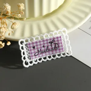 Exquisite lace embroidery patch with purple checkered center and cute handmade details for clothing DIY.