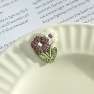 Close-up of cute floral embroidery patch, 3d flower design for handmade DIY apparel.