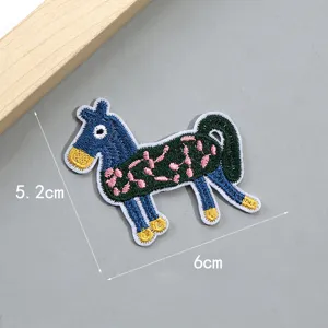 Detailed view of the colorful cartoon pony embroidered patch, delicate DIY fabric applique.