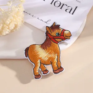 Cute cartoon horse embroidery patch close up detail view, colorful thread decorative applique.