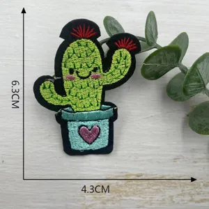 Detailed shot of cute cartoon cactus embroidery patch with pot, perfect for DIY clothing decor.