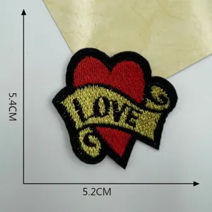 Embroidered heart patch detail view showing neat stitching, ribbon design, and size.