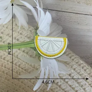 Close-up of cute lemon slice embroidered patch, exquisite stitching and bright yellow details.