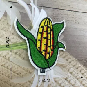 Close-up detail of a colorful embroidered corn patch featuring vibrant yellow and green threads.