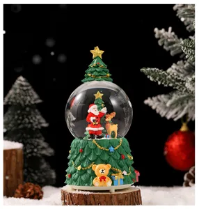 Christmas snow globe detail shot, resin Santa Claus and bear figurine desktop decoration.