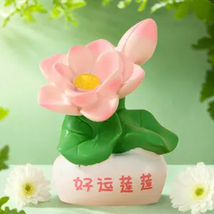 Lotus flower ornament detail showing pink petals and green leaves on a white desk base.