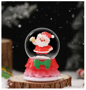 Christmas snow globe detail with cute Santa Claus figurine on red base for festive decor view