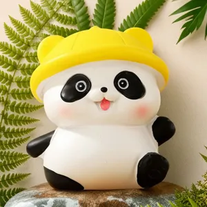 Close-up detail shot of the cute cartoon panda figurine with a yellow hat for office decor.