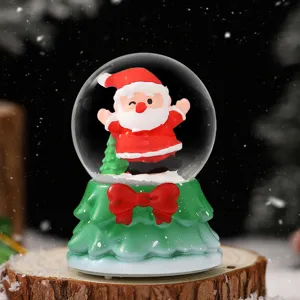 Christmas snow globe decoration with cute Santa Claus figure for holiday desktop home decor.