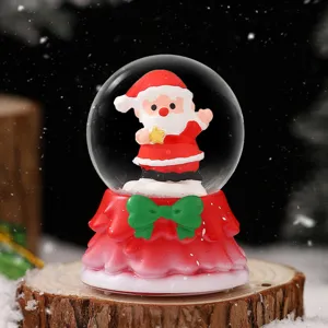 Christmas snow globe ornament with cute Santa figure and red base, desktop holiday decor.
