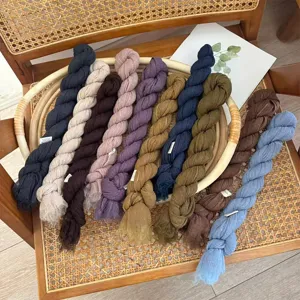 Detail view of solid color pleated narrow long scarves in various rich colors displayed together.