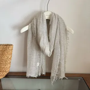 Lightweight breathable neutral grey scarf with frayed edges, soft and elegant accessory.