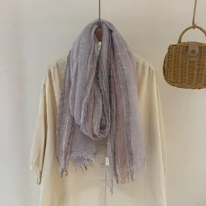 Detailed view of the draped vintage striped scarf showing textured fabric and soft color.