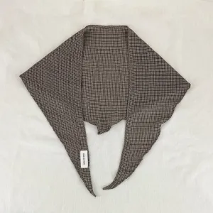 Detail shot of the brown plaid rhombus scarf, showing fine texture and unique cut.