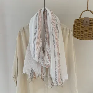 Detailed view of a retro striped crinkled scarf draped nicely for a cozy forest style look.