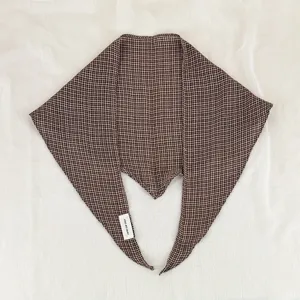 Detailed view of the brown houndstooth pattern diamond scarf neckerchief fabric texture