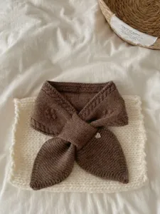 Cozy brown knitted neck warmer close-up, soft texture detail for autumn and winter warmth.