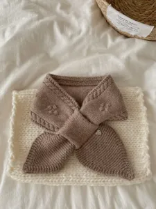 Knit short scarf detail, soft texture and cozy wear for women in autumn and winter warmth.