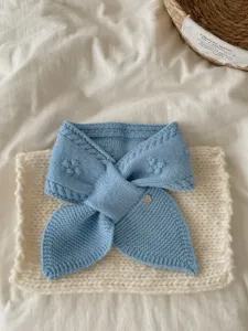 Soft knitted short scarf detail view, blue winter neckerchief with jacquard pattern.