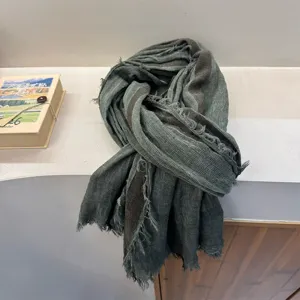Close-up detail of vintage distressed striped cotton linen scarf, showing textured fringe edge.