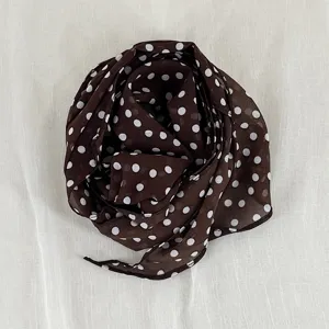 Brown polka dot scarf detail, lightweight sheer fabric design for elegant neck and hair styling.