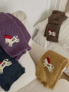 Cozy knitted scarf with cute embroidered pony patch, warm soft winter neck accessory.