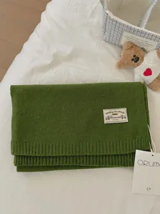 Cozy green knitted winter scarf for women, soft warm wool blend fashion neck wrap accessory.