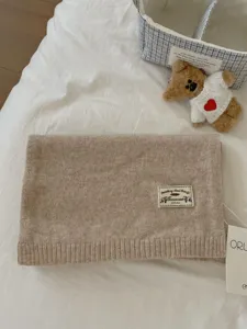 Cozy beige knit scarf for women, soft warm winter wool scarf with stylish woven label.