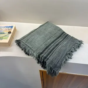 Cozy green fringed scarf with subtle stripes, elegant literary style shawl for daily wear.