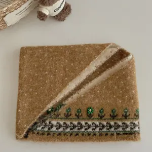 Cozy knit neck warmer winter scarf featuring fair isle jacquard and cute beaded flower details.