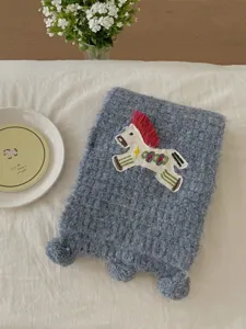 Cozy knitted winter scarf with cute embroidered pony patch and pom pom tassels for women.