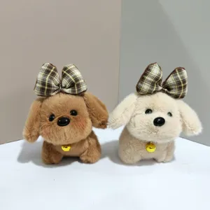 Close-up detail of cute plush puppy keychains with plaid bows and gold bells for bags.