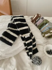 Cozy winter knitted fuzzy striped scarf with pom-pom design, soft and warm accessory for women.